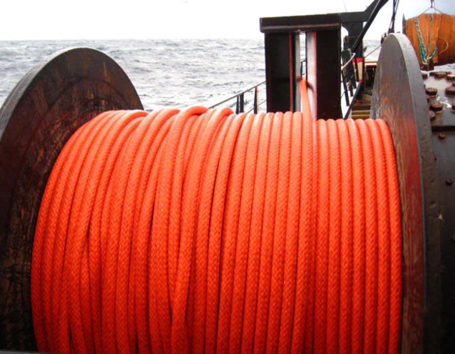 Large spool of bright orange commercial fishing rope on a vessel, engineered by Samson Rope