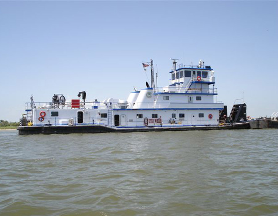 River barge on inland waterway using Samson Rope for towing and dredging